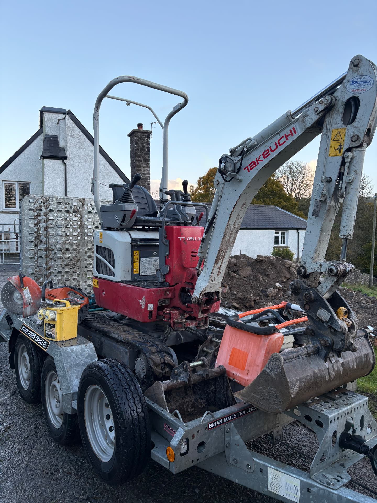 Takeuchi mini digger on our trailer with a disc cutter, wacker plate and transformer