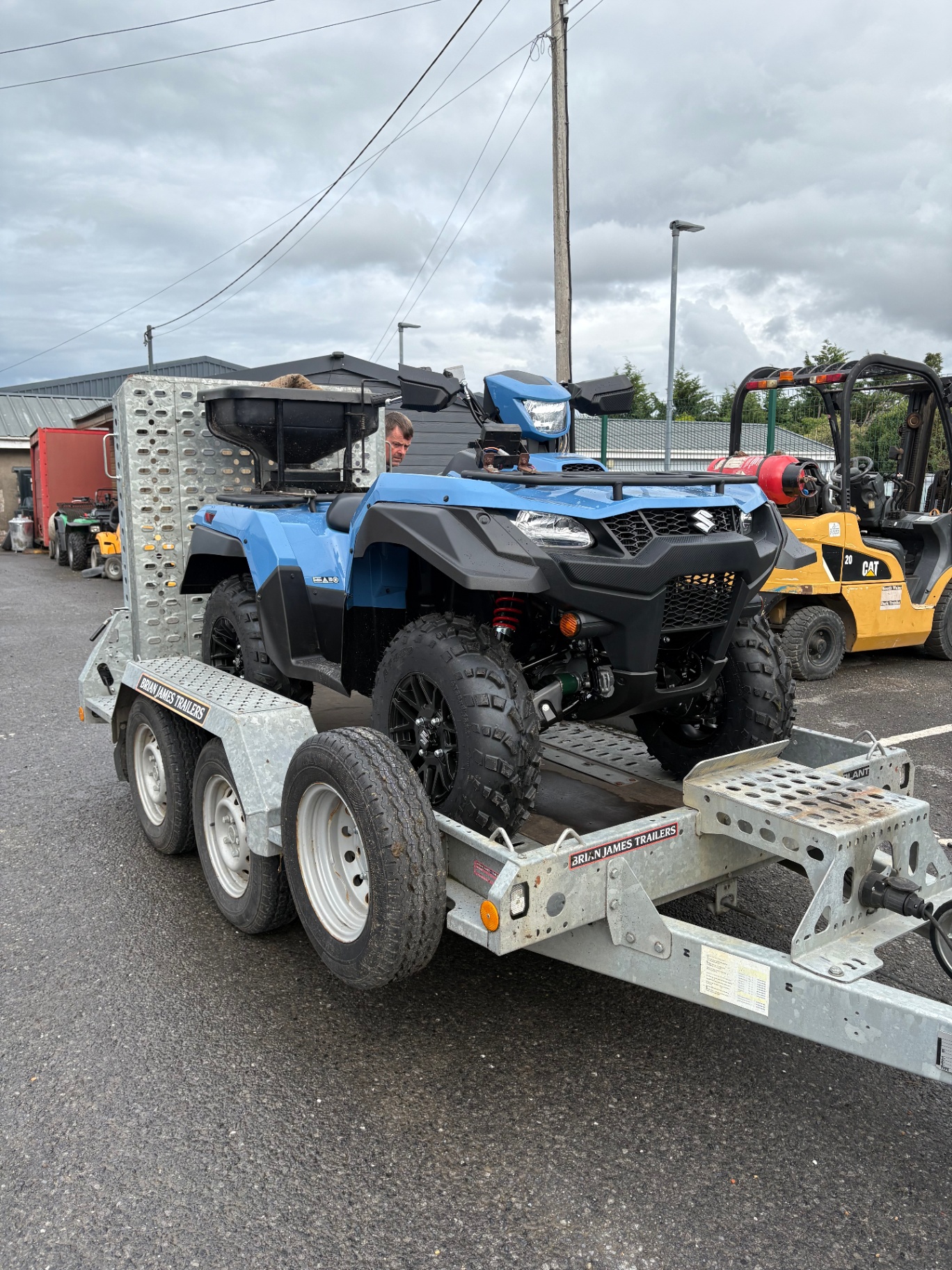 Blue Suzuki KingQuad ATV loaded on our trailer
