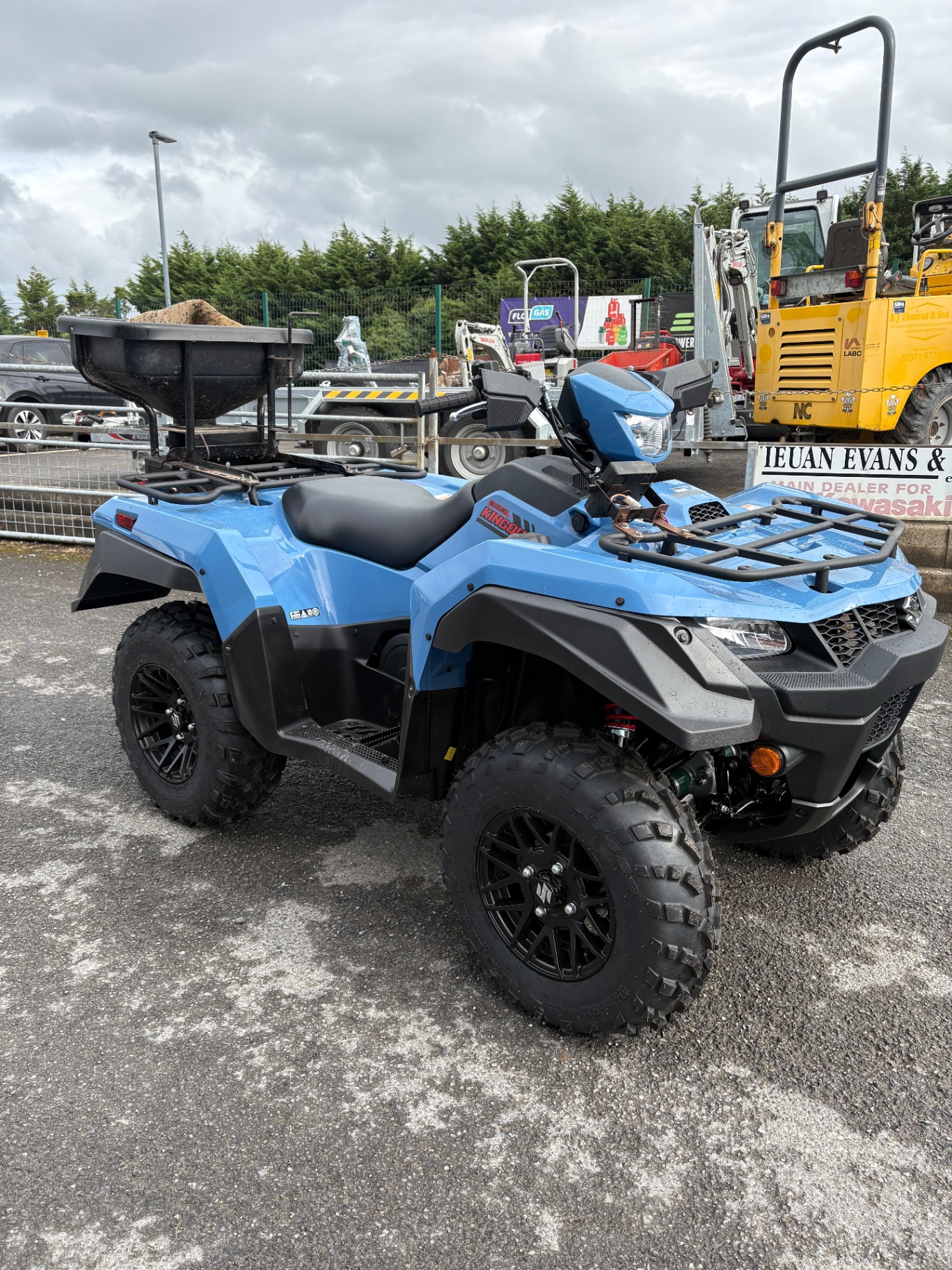 Blue Suzuki KingQuad ATV in our yard