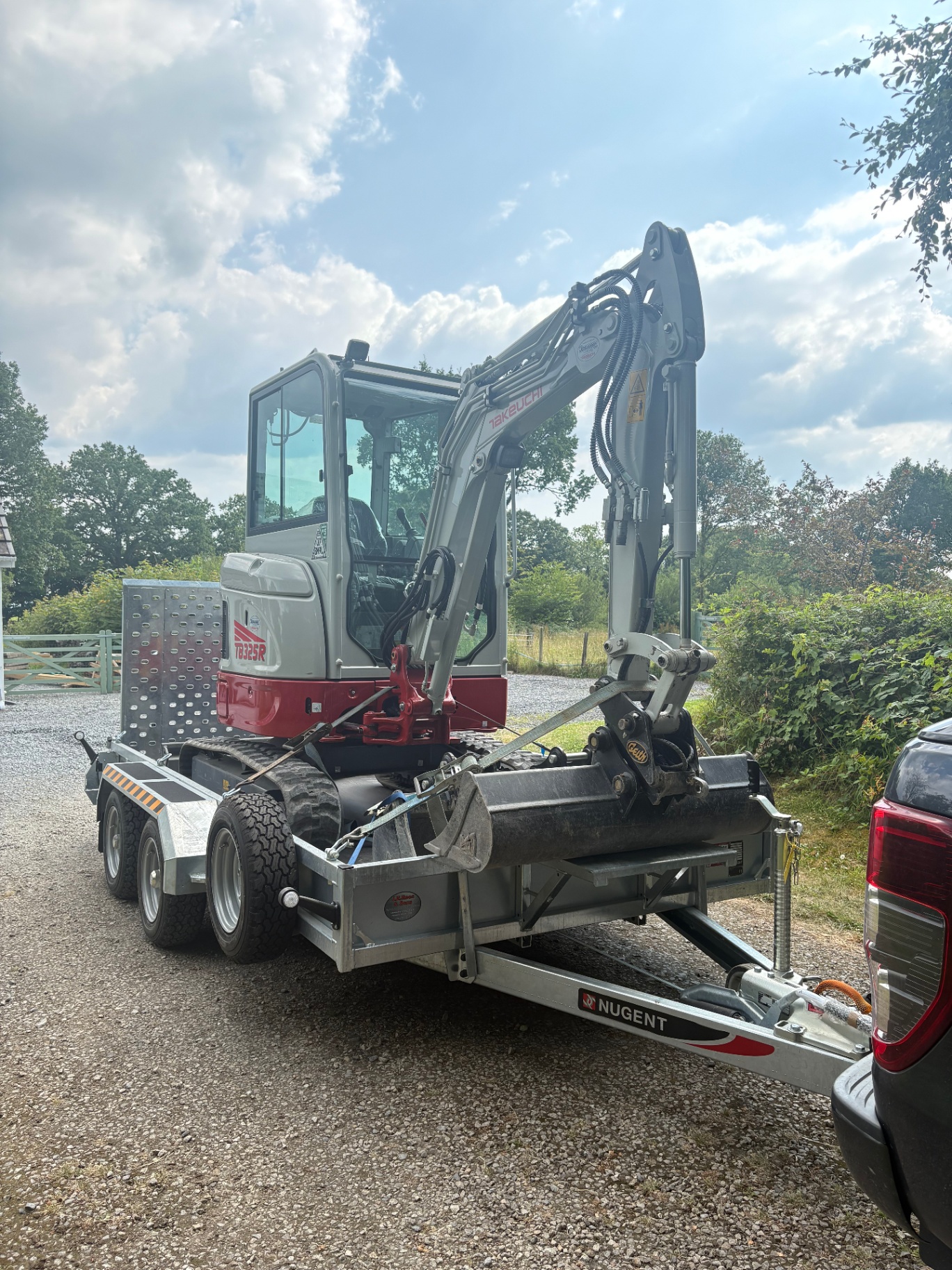 Takeuchi TB325R mini digger strapped down on our trailer