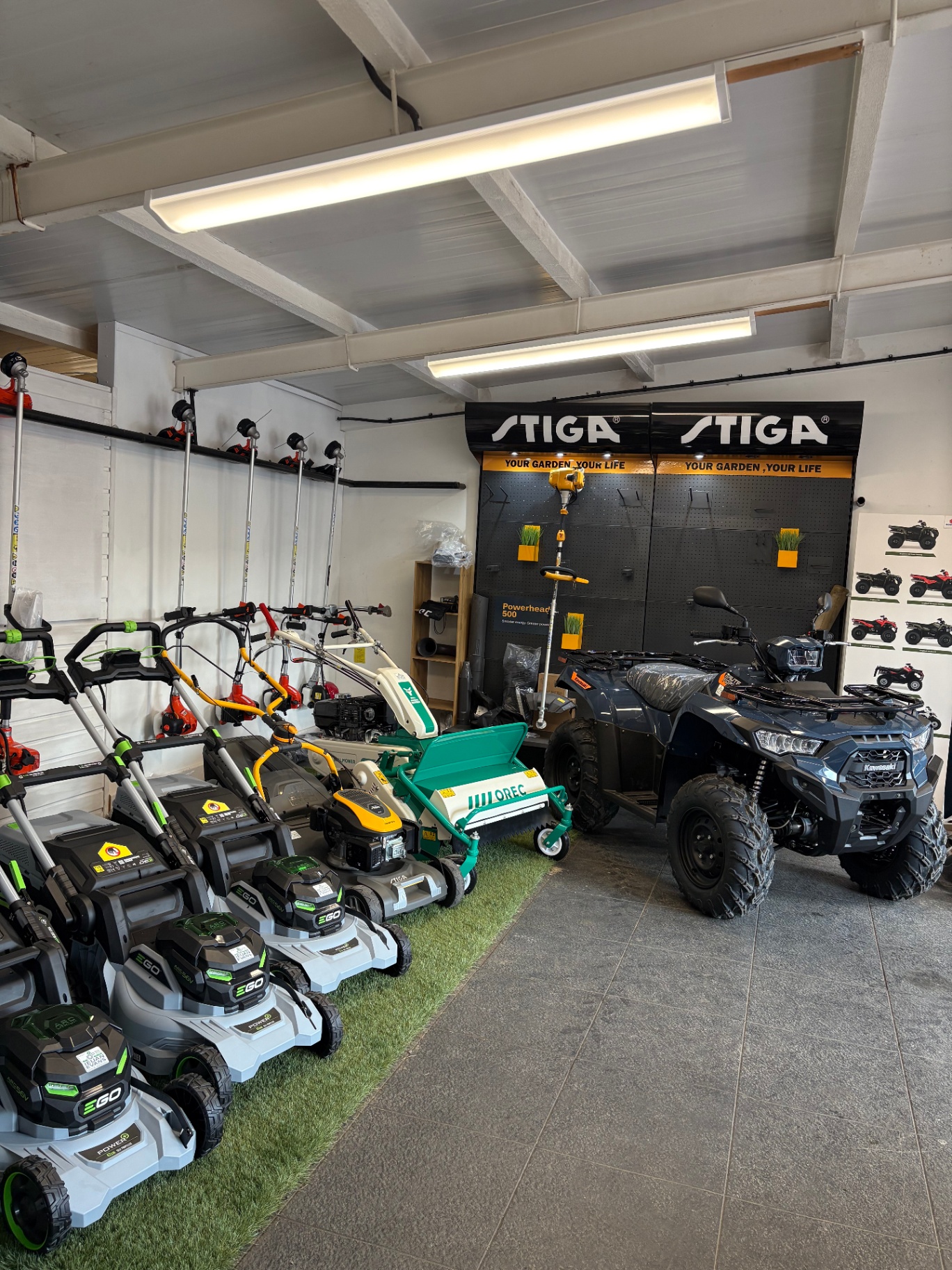 Orec flail mower beside a Kawasaki ATV in our showroom