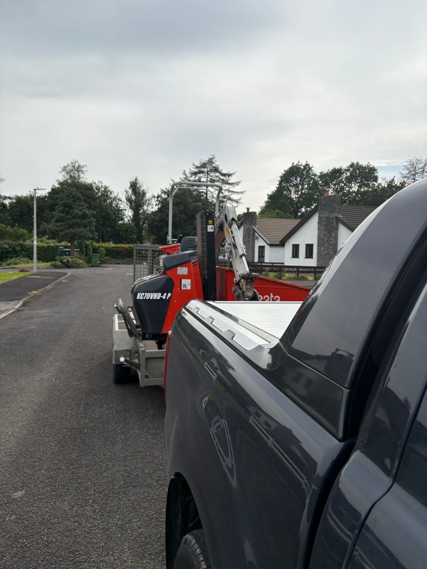 Our pickup towing a tracked dumper and mini digger