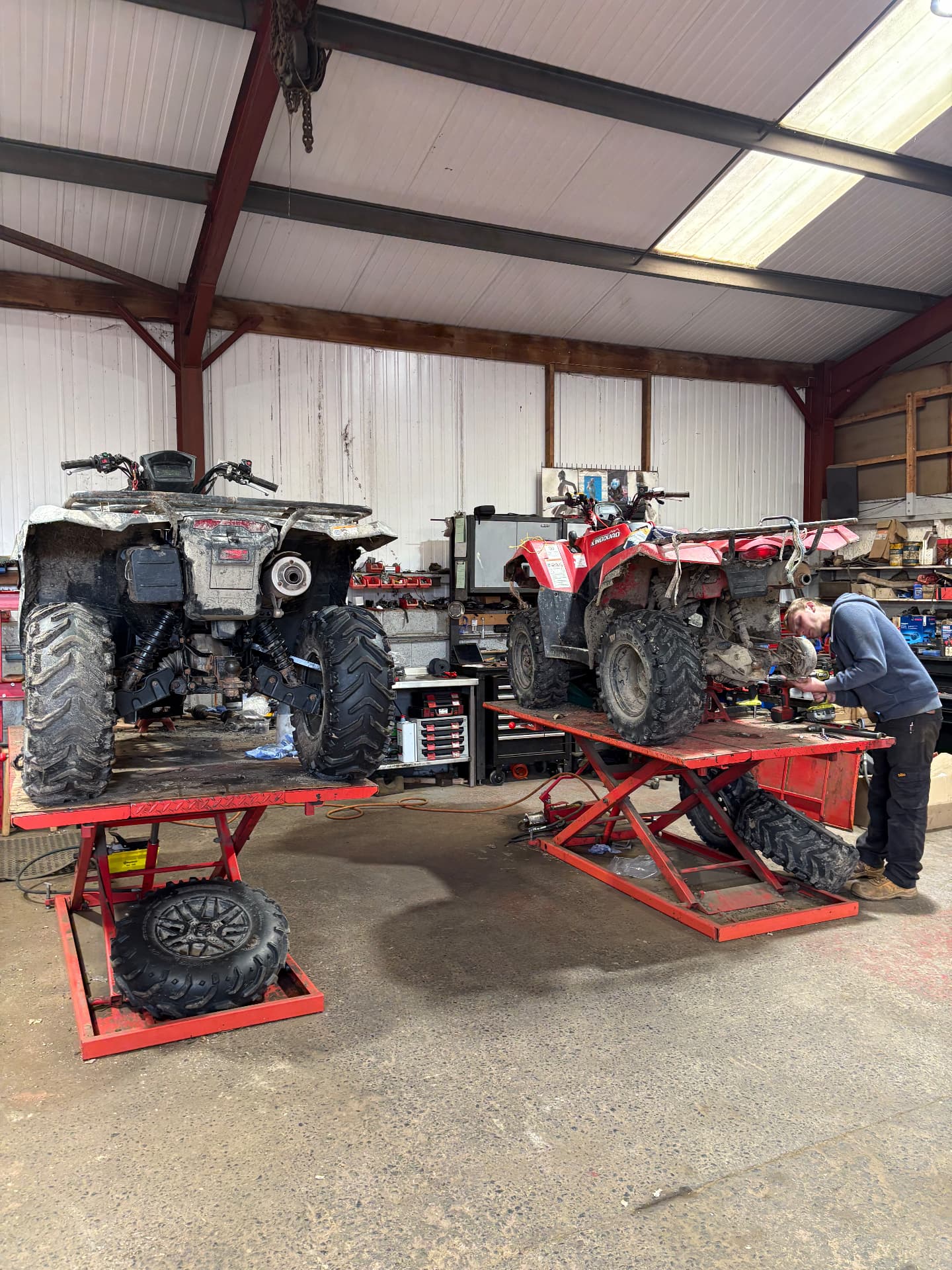 Two ATVs up on the ramps in our workshop