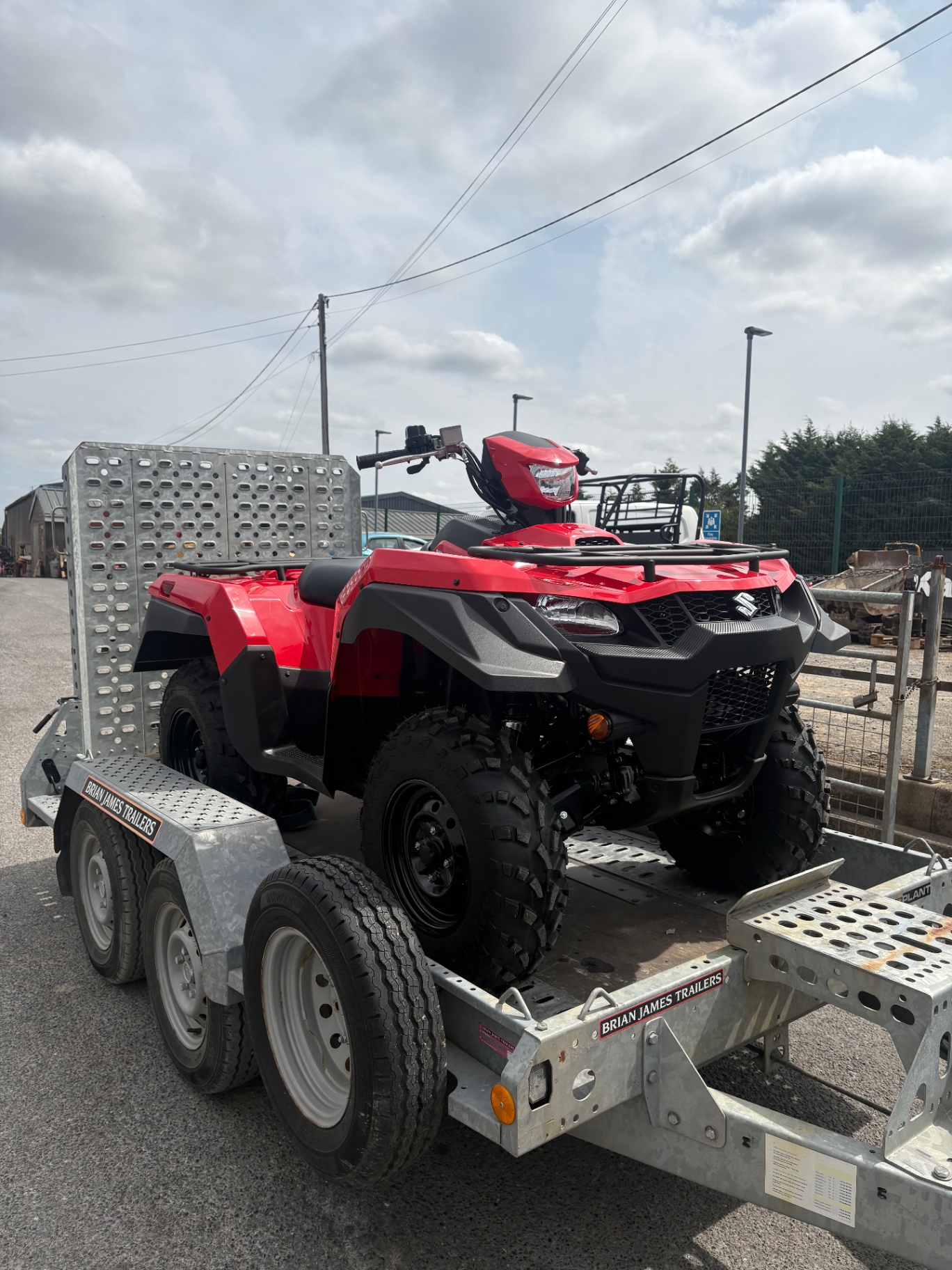 Red Suzuki KingQuad ATV loaded on our trailer
