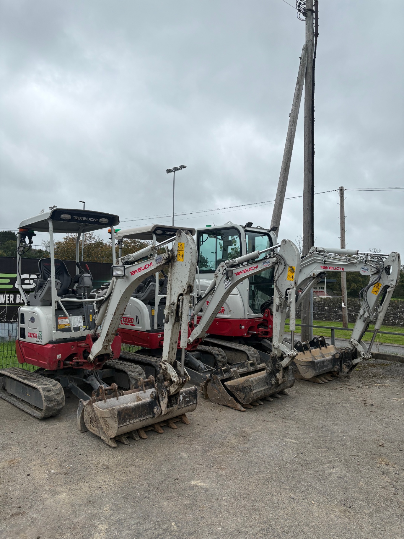 Takeuchi mini diggers lined up with buckets