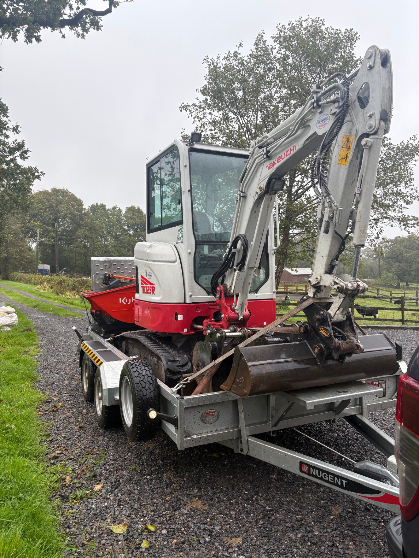 Takeuchi TB325R mini digger delivered down a country lane